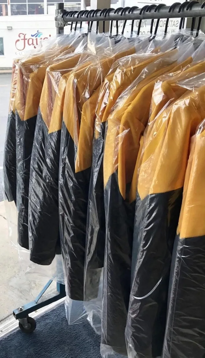 Multiple matching garments hanging together on a rack