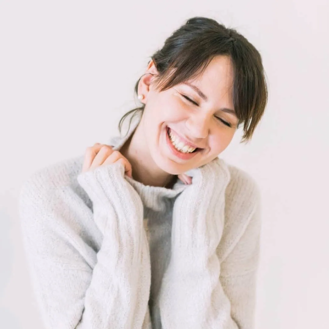 A woman in a pale knit sweater
