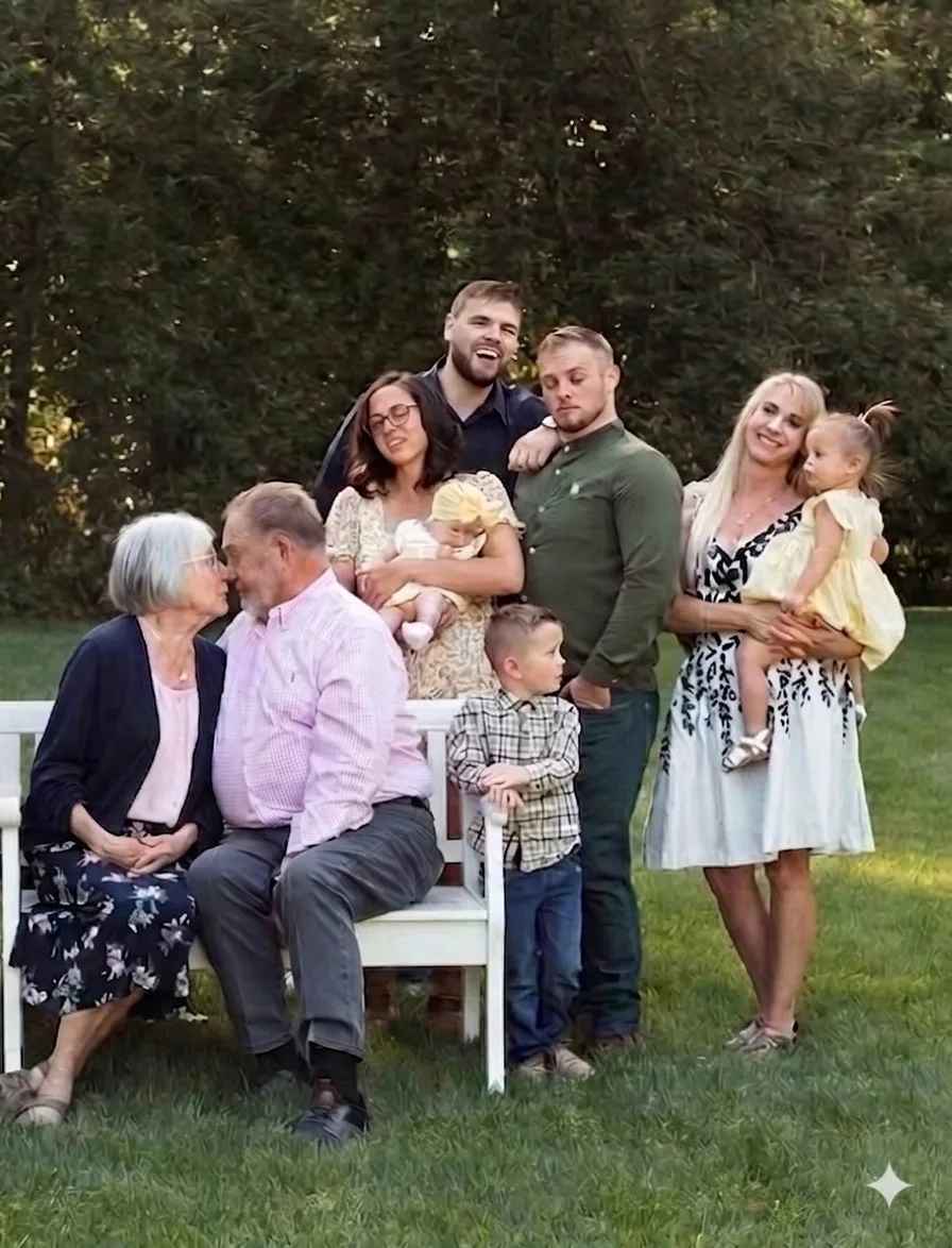 An outdoor group portrait with children and a seated couple