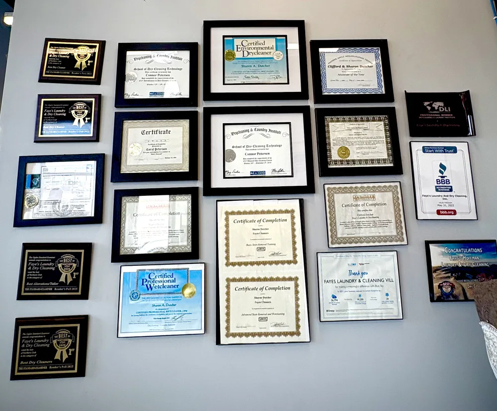 A wall at Faye's with framed certificates hanging in rows