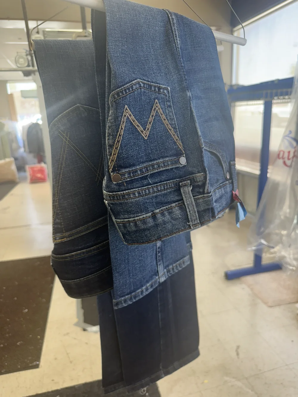 Pressed jeans hanging inside the Faye's shop