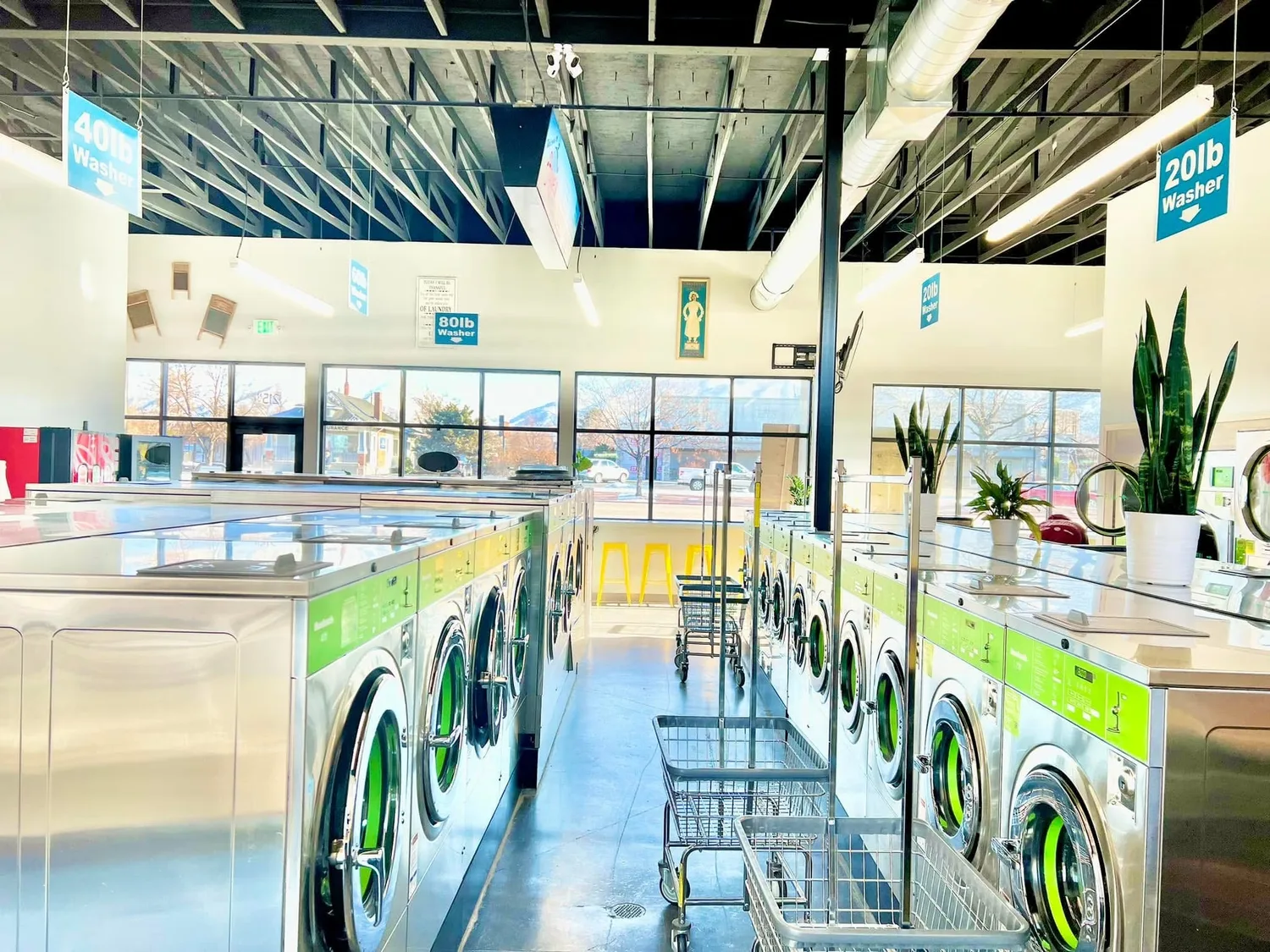 Bright Faye's laundromat with an aisle of front-loading washers under clean lighting