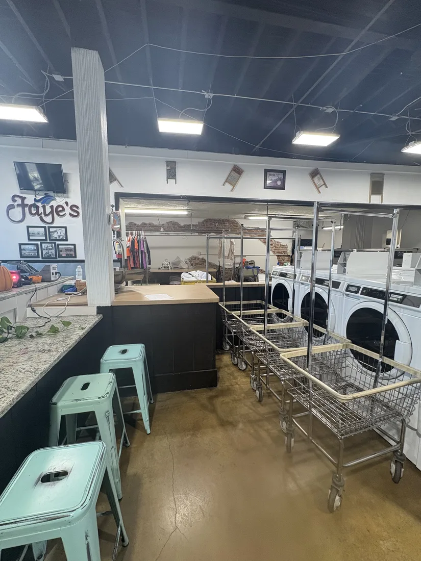 Row of washers with laundry carts ready for loading
