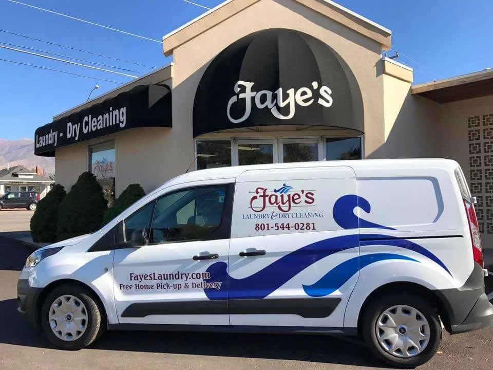 Faye's pickup and delivery van parked outside a Faye's storefront